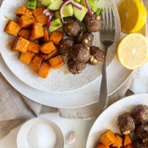 Feta-stuffed meatballs with olive and cucumber salad and roasted sweet potatoes