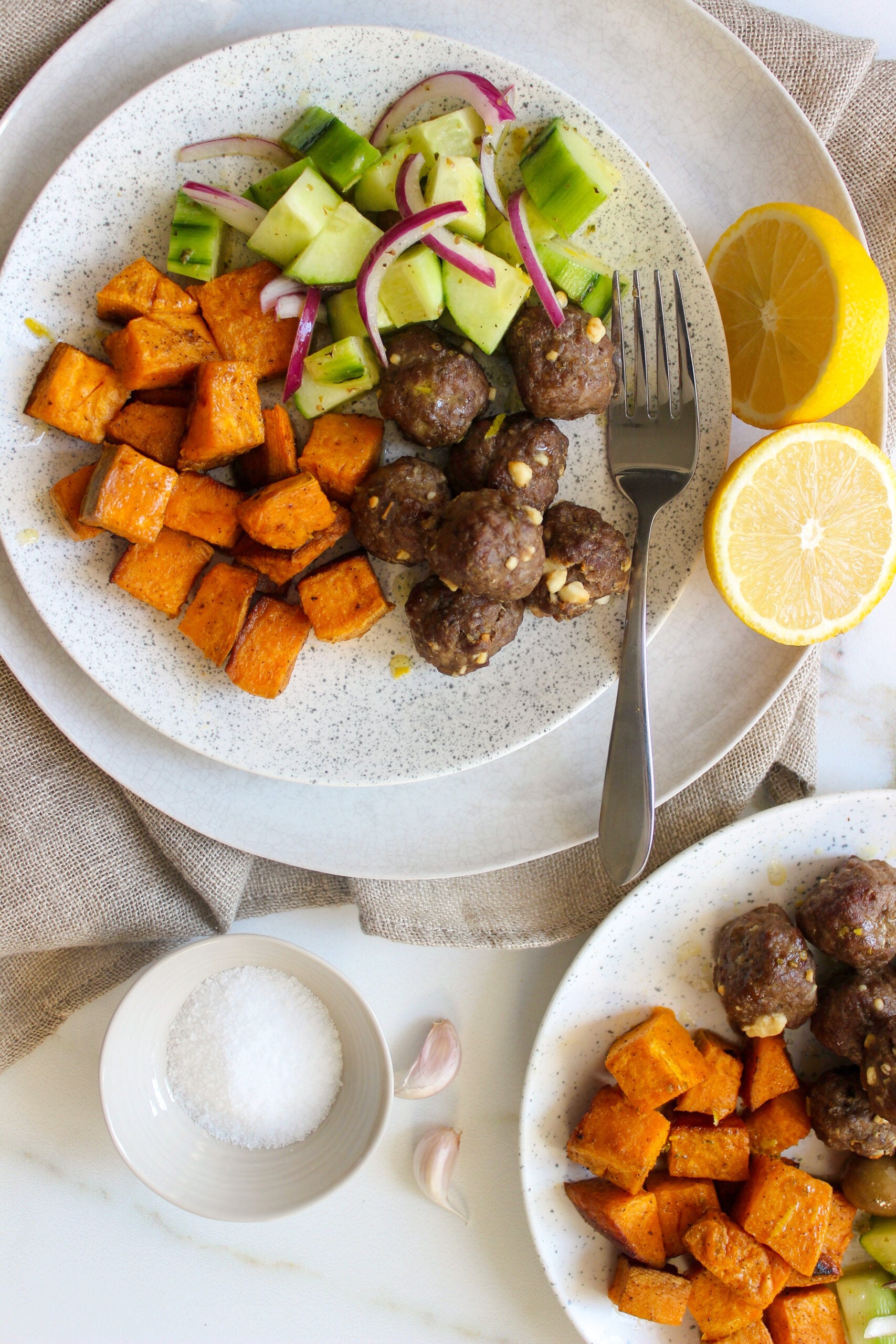 Feta-stuffed meatballs with olive and cucumber salad and roasted sweet potatoes
