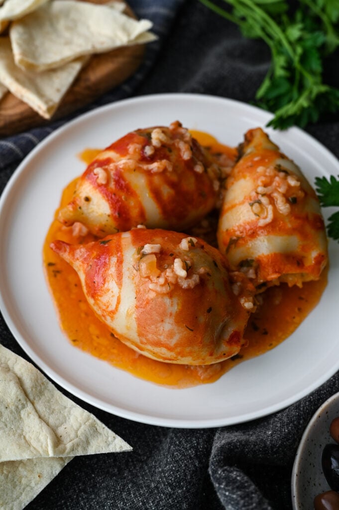 Baked squid stuffed with rice and herbs and baked in a tomato sauce.