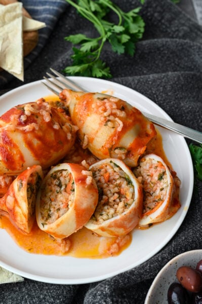 Baked squid stuffed with rice and herbs and baked in a tomato sauce.