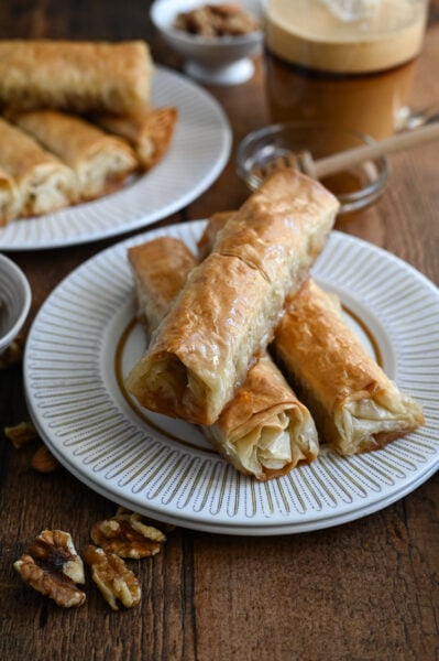 Saragli or Baklava cigars are a traditional Greek syrup soaked dessert make with phyllo dough and nuts