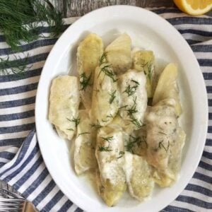 Greek cabbage rolls filled with rice, meat and herbs, topped with a rich egg lemon sauce