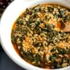 A classic recipe for Greek spanakorizo, a spinach and rice dish served in a tomato base.