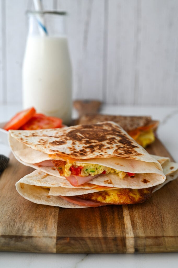 These easy breakfast tortilla wraps are full of eggs, veggies, cheese and ham for the best make-ahead meal!