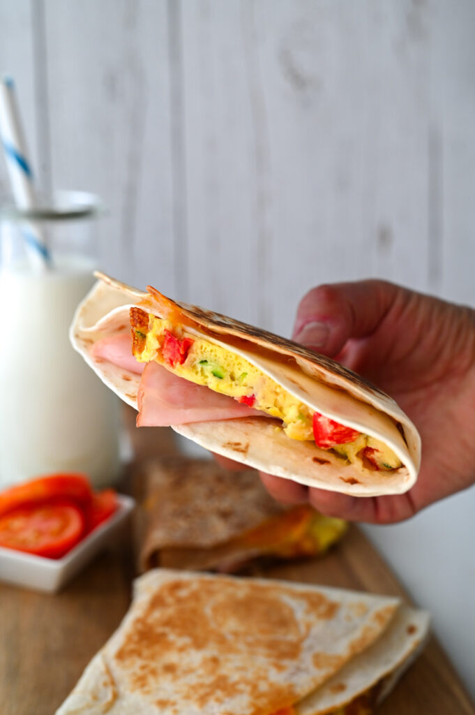 These easy breakfast tortilla wraps are full of eggs, veggies, cheese and ham for the best make-ahead meal!