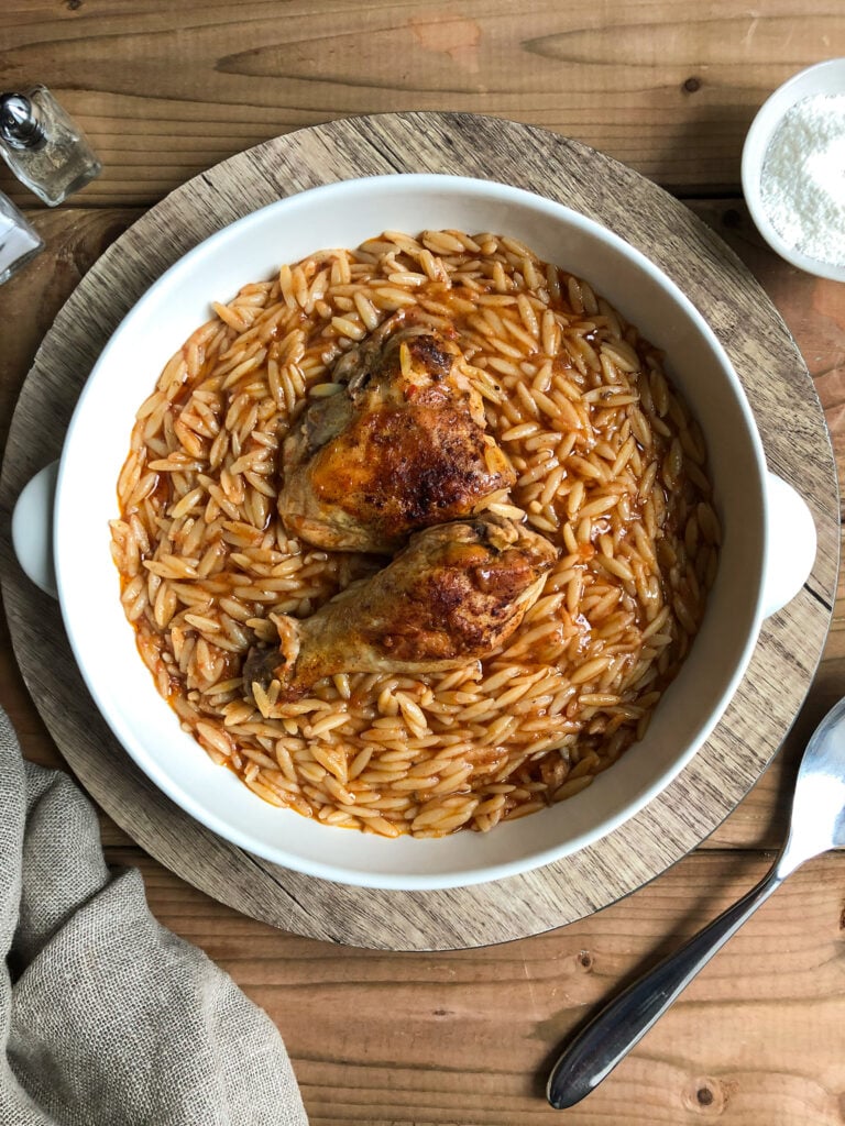 Youvetsi with chicken in pure comfort food. Tender chicken and wonderful orzo baked in a rich tomato based sauce.