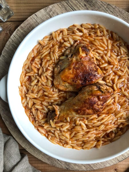 Youvetsi with chicken in pure comfort food. Tender chicken and wonderful orzo baked in a rich tomato based sauce.