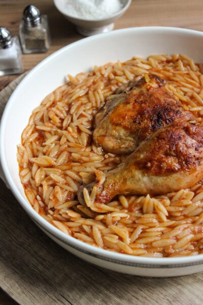 Youvetsi with chicken in pure comfort food. Tender chicken and wonderful orzo baked in a rich tomato based sauce.