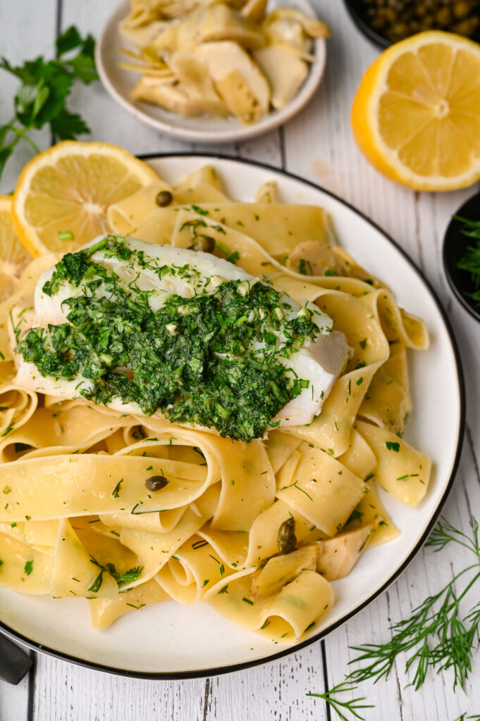 Fresh herb baked cod with pasta and marinated artichokes is an easy and elegant meal.