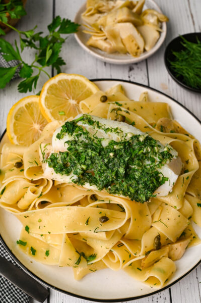 Fresh herb baked cod with pasta and marinated artichokes is an easy and elegant meal.