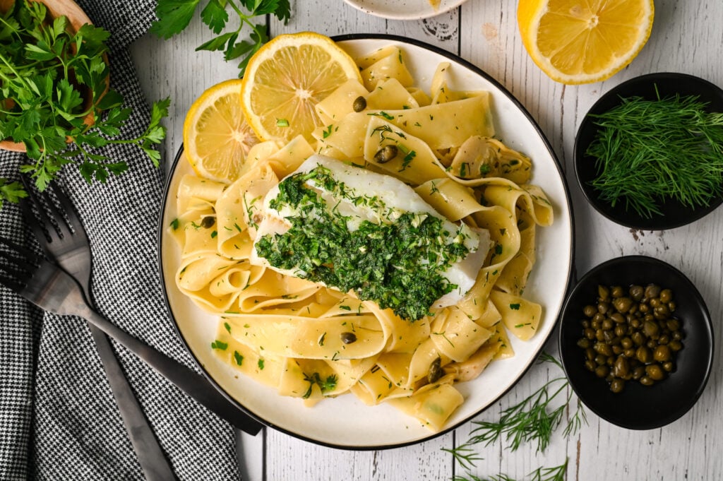 Fresh herb baked cod with pasta and marinated artichokes is an easy and elegant meal.