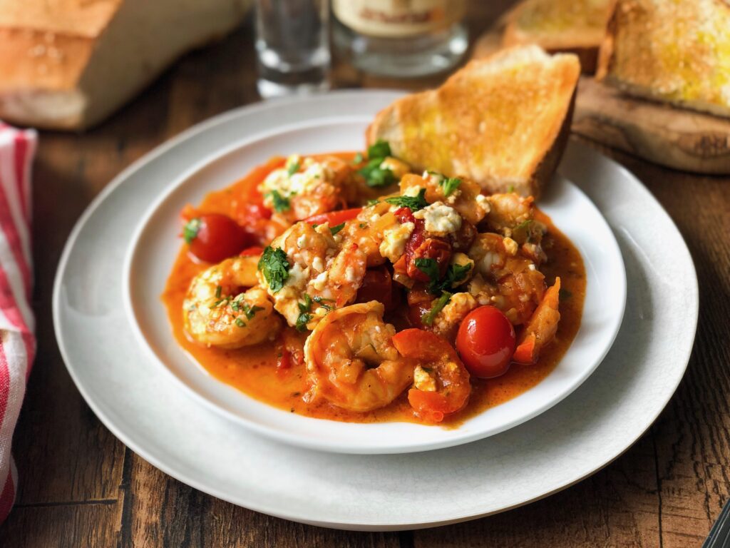 Shrimp cooked in a rich and spicy tomato sauce with ouzo and feta