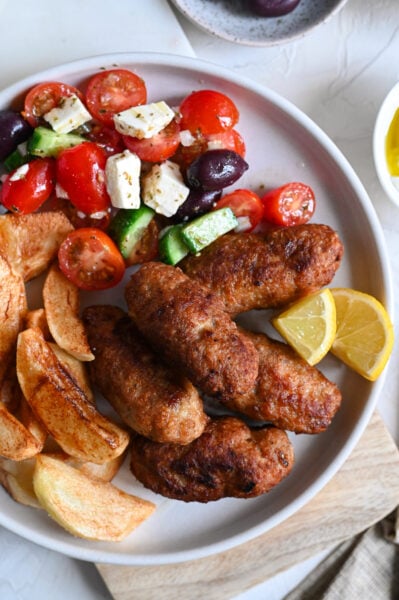 Biftekia with french fries is a classic Greek meal of meat patties and fried potatoes.