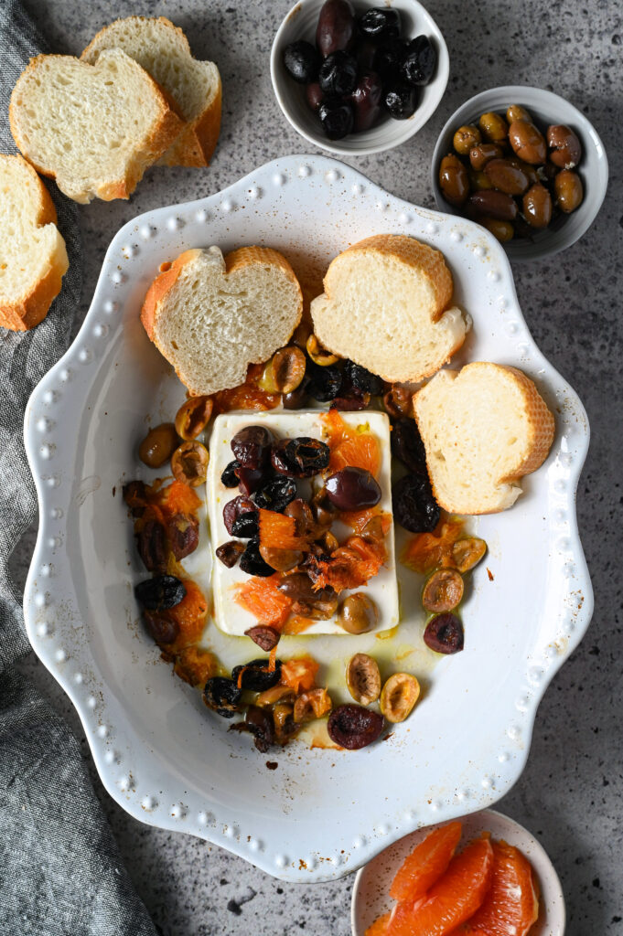 Easy Greek appetizer of baked feta with orange and olives to serve with bread or crackers.