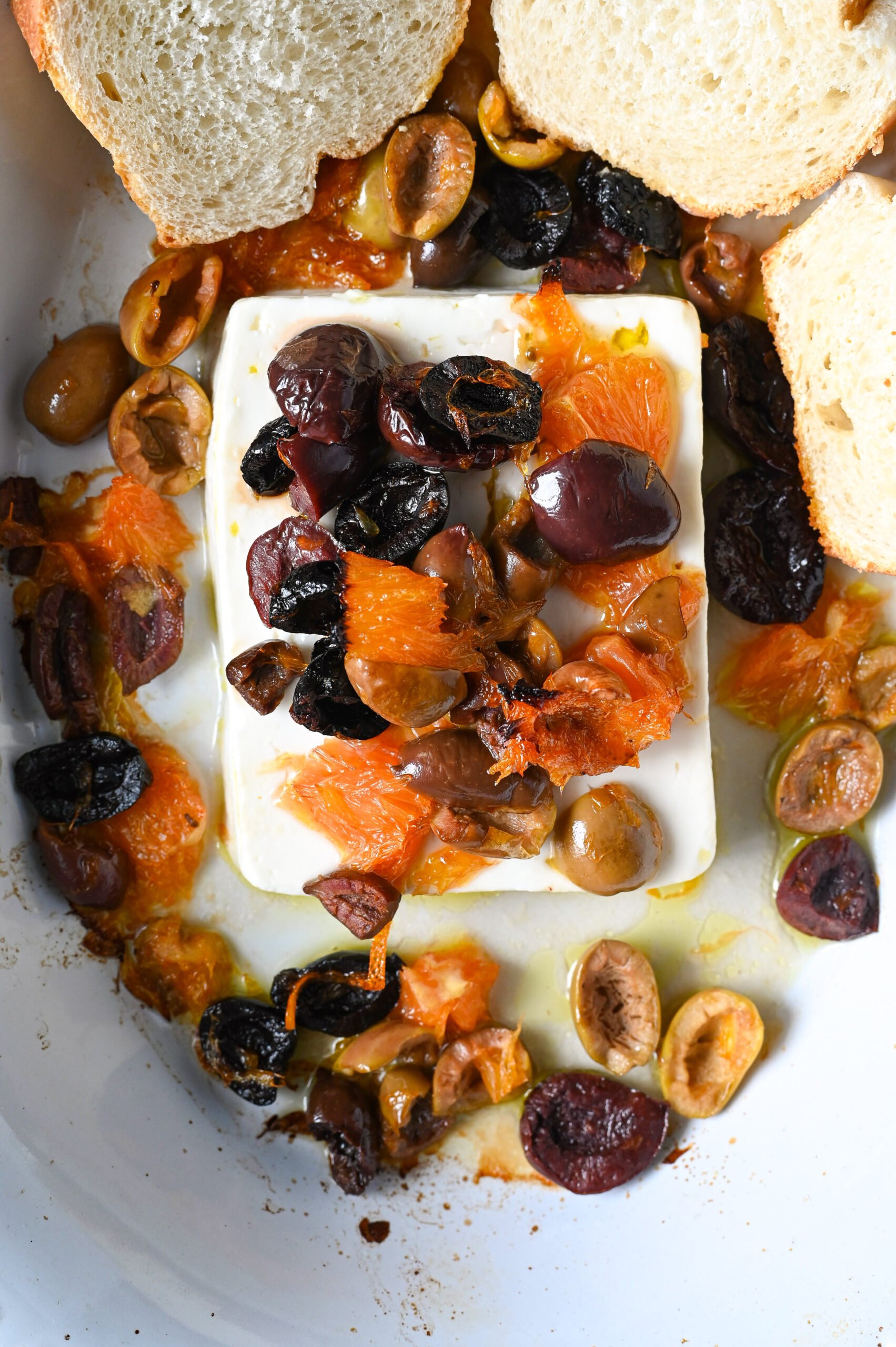 Easy Greek appetizer of baked feta with orange and olives to serve with bread or crackers.