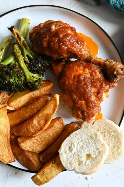 Chicken kokkinisto, or stewed chicken in a rich tomato sauce served with homemade French fries.