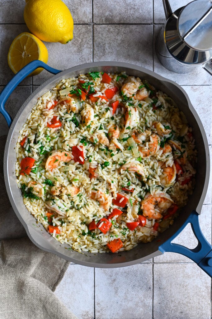 A one skillet meal of shrimps and rice full of vegetables and herbs.
