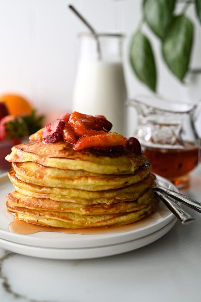 Easy orange ricotta pancakes topped with orange and strawberry compote.