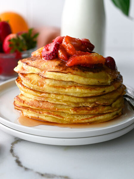 Easy orange ricotta pancakes topped with orange and strawberry compote.