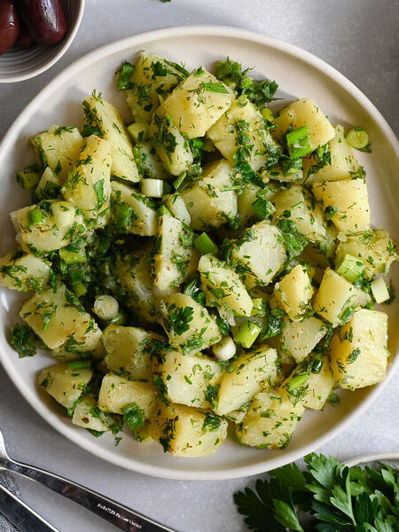 A Greek potato salad made with fresh herbs and a light lemon vinaigrette.