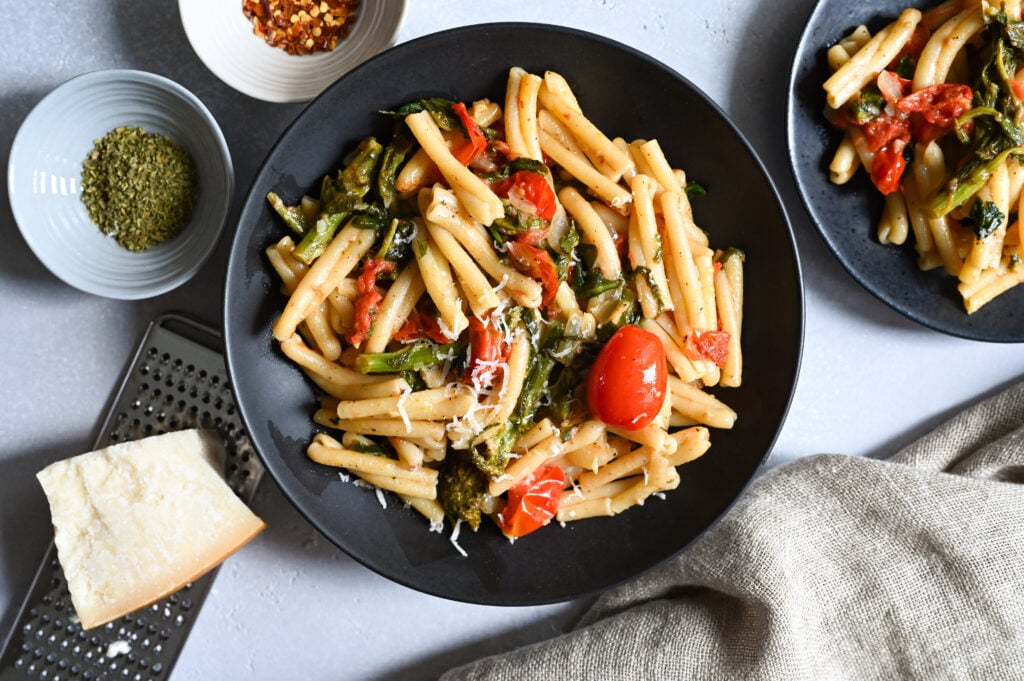 An easy, vegetarian pasta recipes loaded with cherry tomatoes, greens like spinach, rapini and cheese!