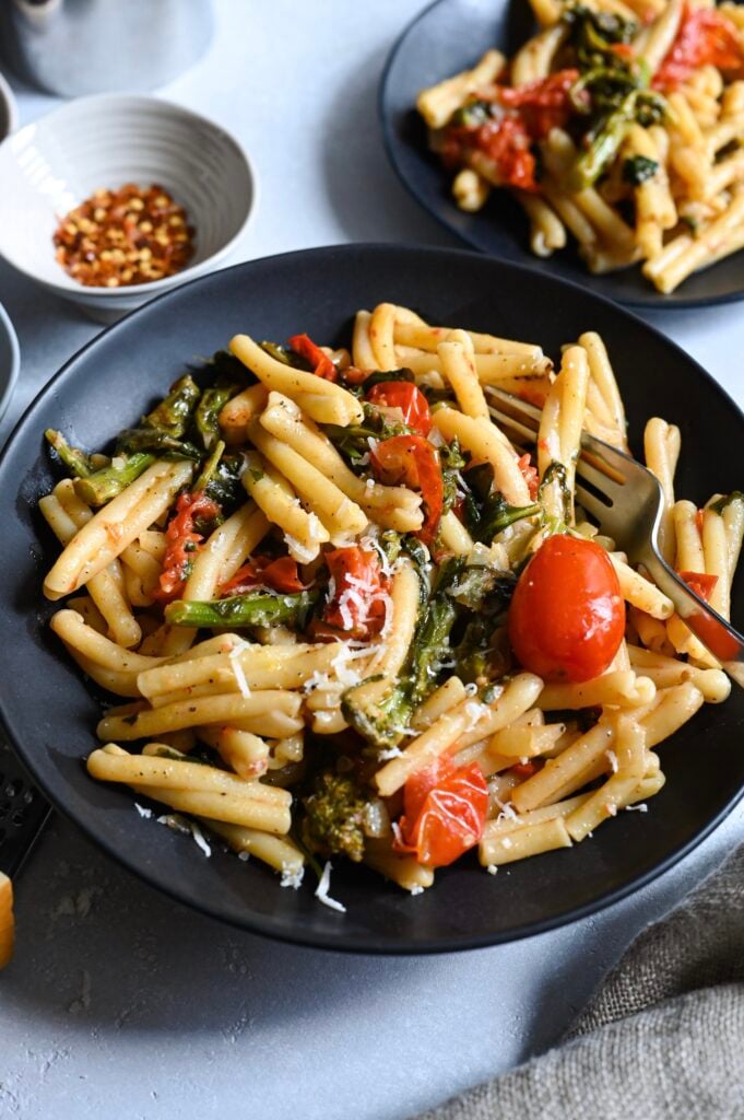 An easy, vegetarian pasta recipes loaded with cherry tomatoes, greens like spinach, rapini and cheese!