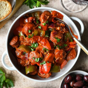 Traditional recipe for spetzofai (spetsofai) - Greek sausages with peppers and tomato recipe.