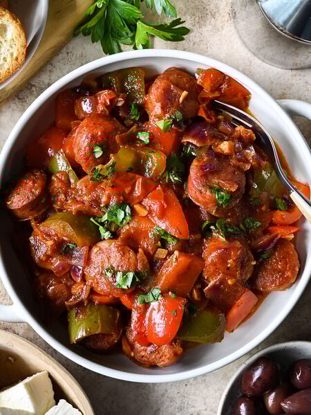 Traditional recipe for spetzofai (spetsofai) - Greek sausages with peppers and tomato recipe.