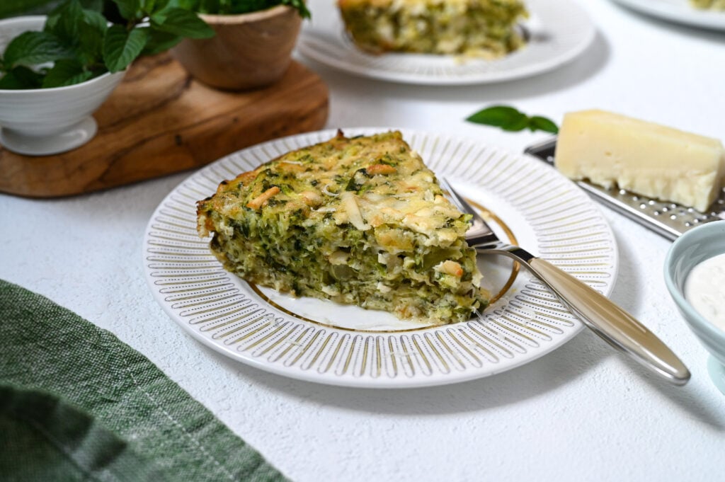 A delicious and easy crustless zucchini tart made with Greek cheese.