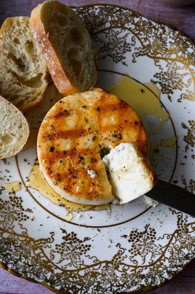 Greek meze of grilled manouri cheese drizzled with honey and topped with cracked black pepper.