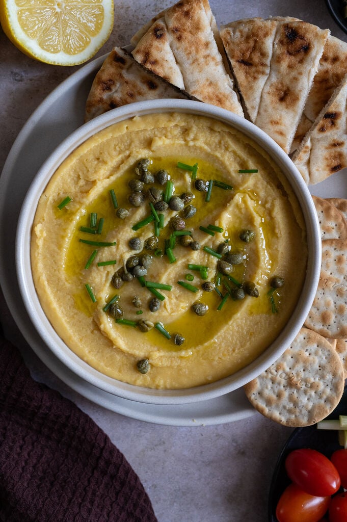 Greek Fava dip or spread topped with capers, chives and drizzled with olive oil.