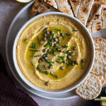 Greek Fava dip or spread topped with capers, chives and drizzled with olive oil.