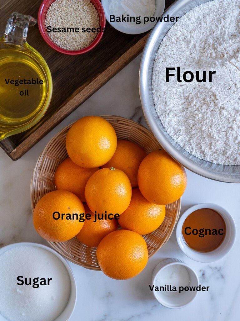 Koulourakia with orange ingredients which include: Vegetable oil, flour, orange juice, cognac, vanilla powder, sugar, baking powder, and sesame seeds