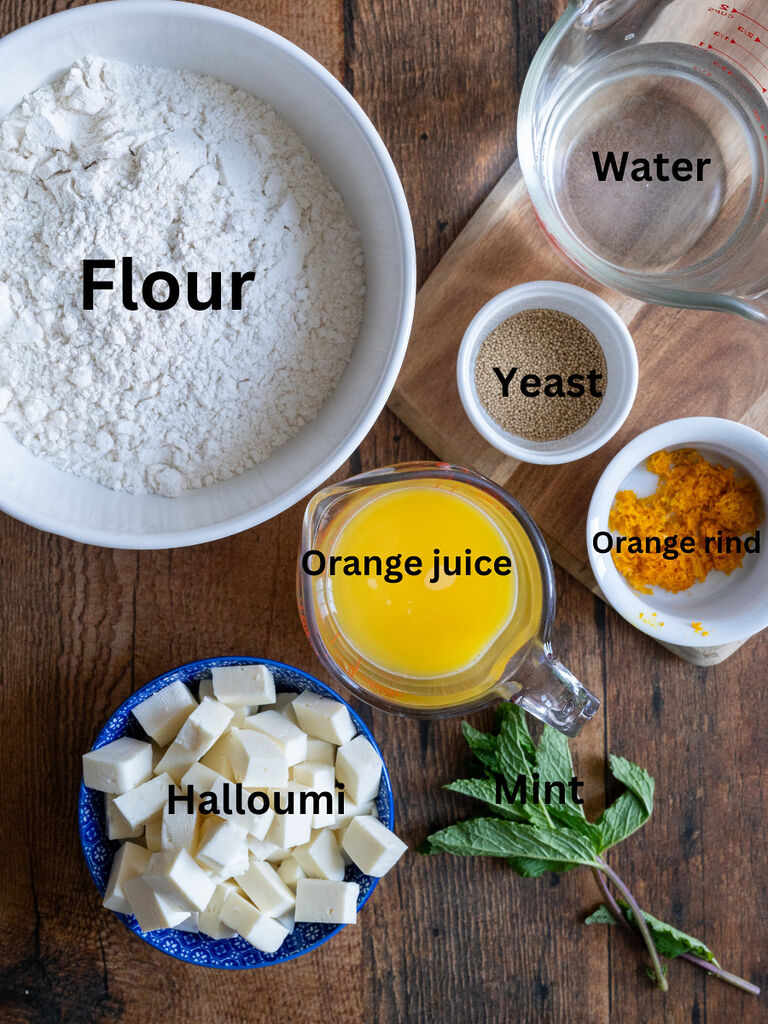 Ingredients for No Knead bread with Halloumi, orange and mint, which includes: Orange juice, flour, halloumi, mint and orange rind, water and yeast.
