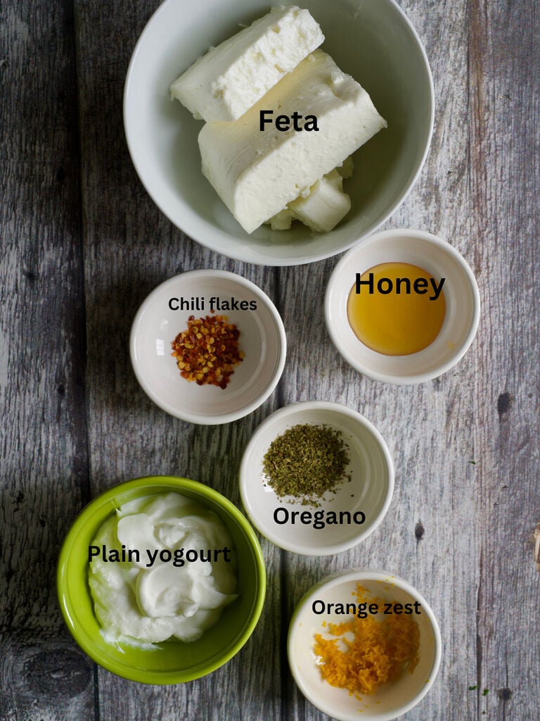 Ingredients for whipped feta recipe, which include: Feta, chili flakes, honey, oregano plain yoghurt and orange zest