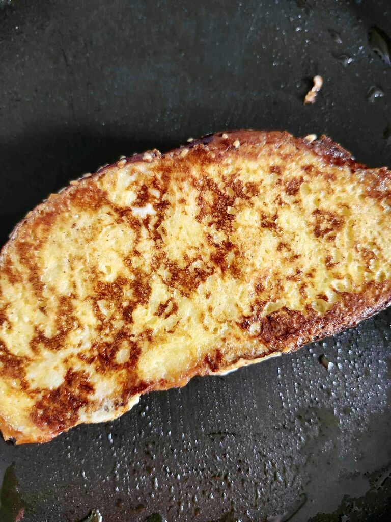 Frying the tsoureki french toast.