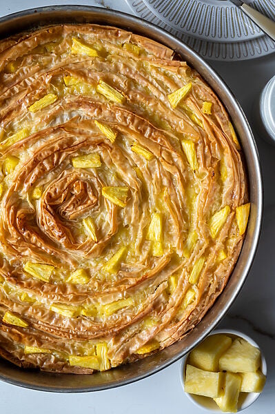 Pineapple and coconut Soufra dessert in a 10 inch stainless steel baking pan.