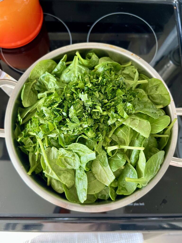 Cooking of the spinach and potato stew.