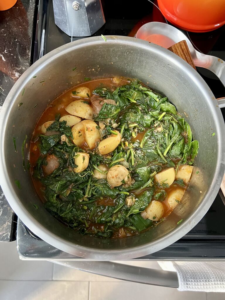 Cooking of the spinach and potato stew.