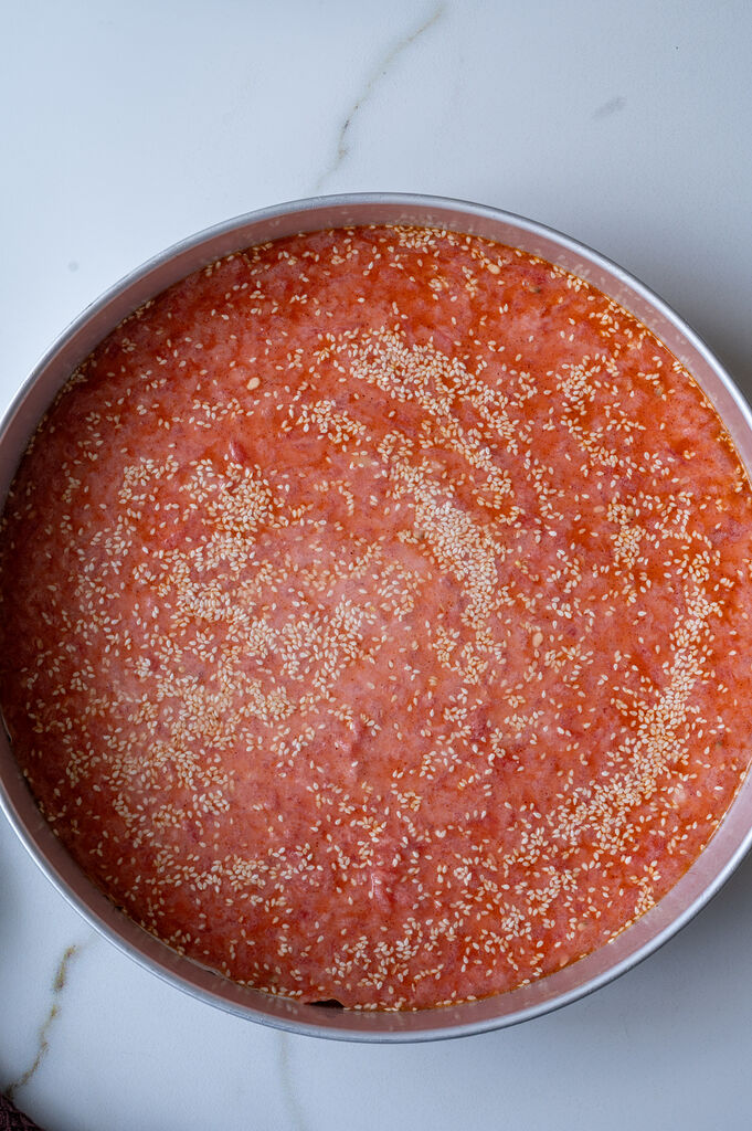 The karpouzopita in a stainless steel baking pan, ready to go into the oven.