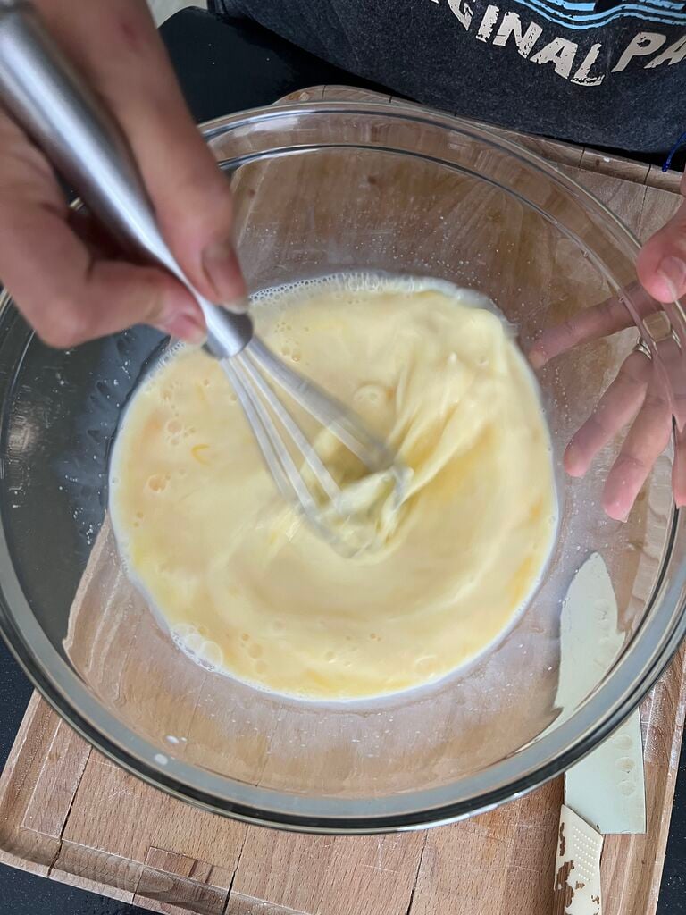 Whisking the eggs.