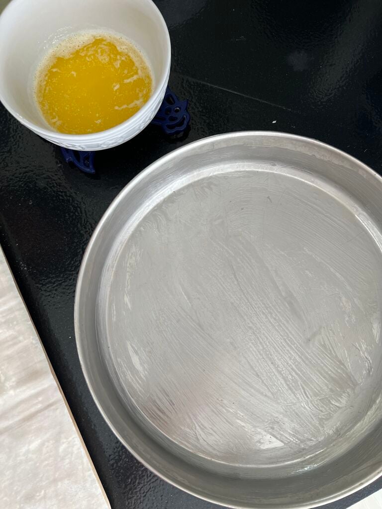 Greasing the baking pan.