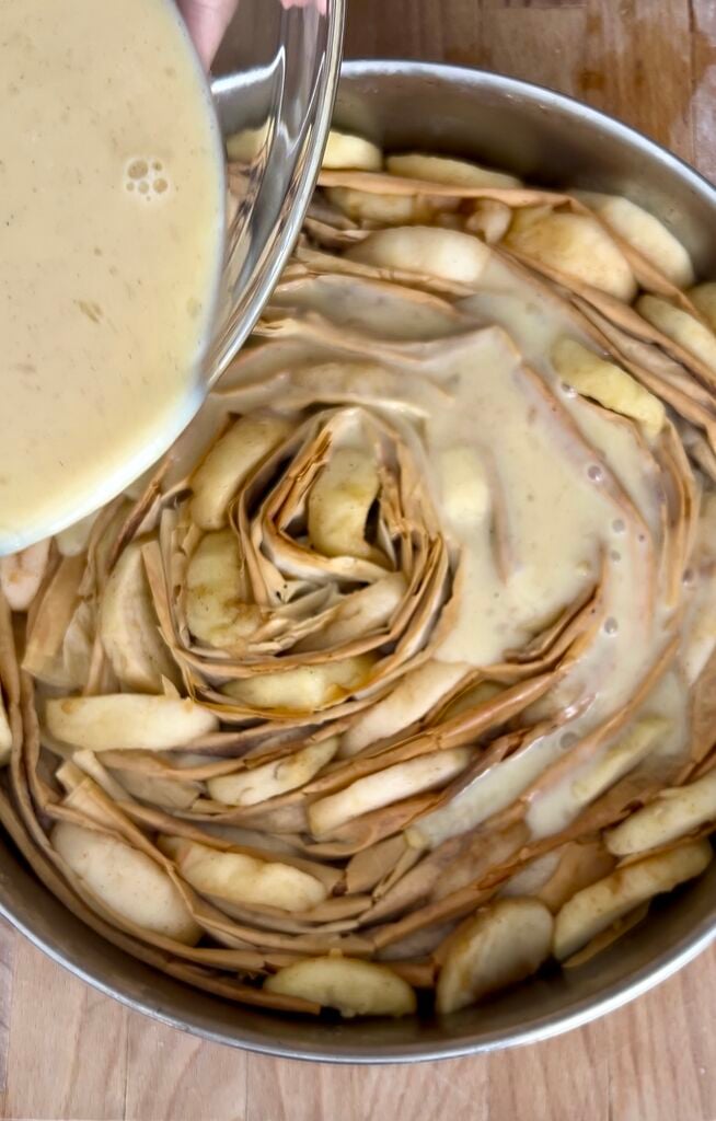 The phyllo (filo) ready to be baked in a stainless steel pan. Custard being poured on it.
