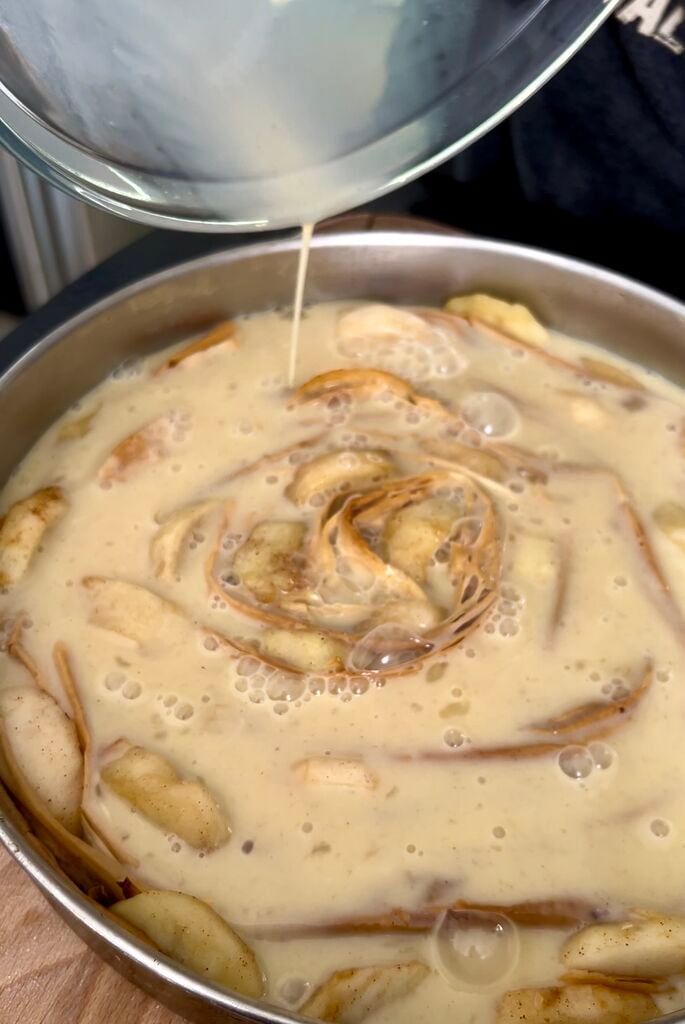The phyllo (filo) ready to be baked in a stainless steel pan. Custard poured over it.