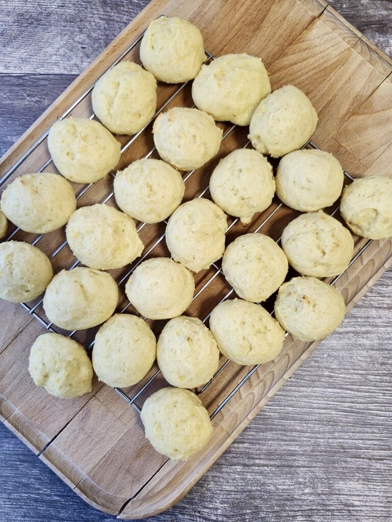 Baked orange ricotta cookies on cooling rack.