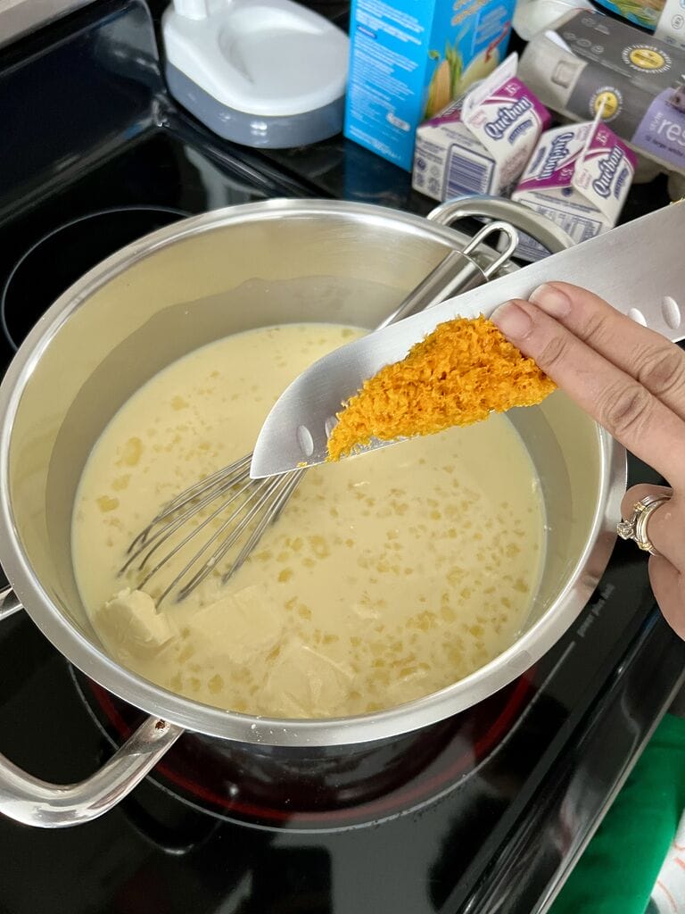 Adding the orange in custard mix.