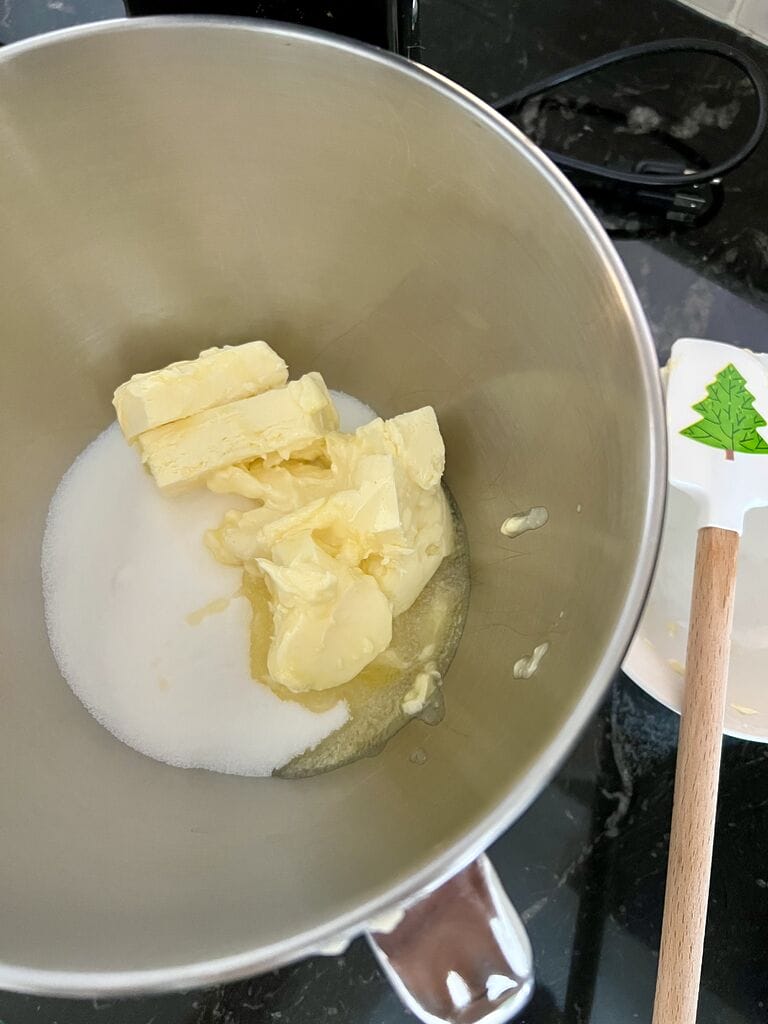 Butter and sugar in mixing bowl, ready to cream.