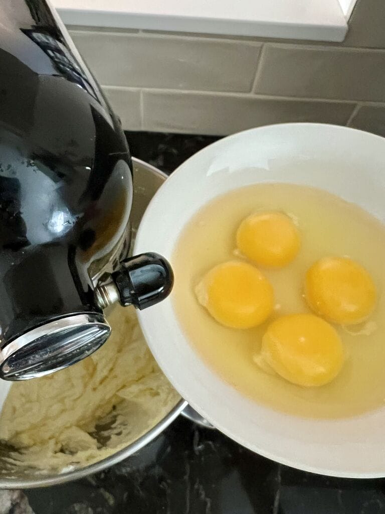 Adding the eggs into the batter.