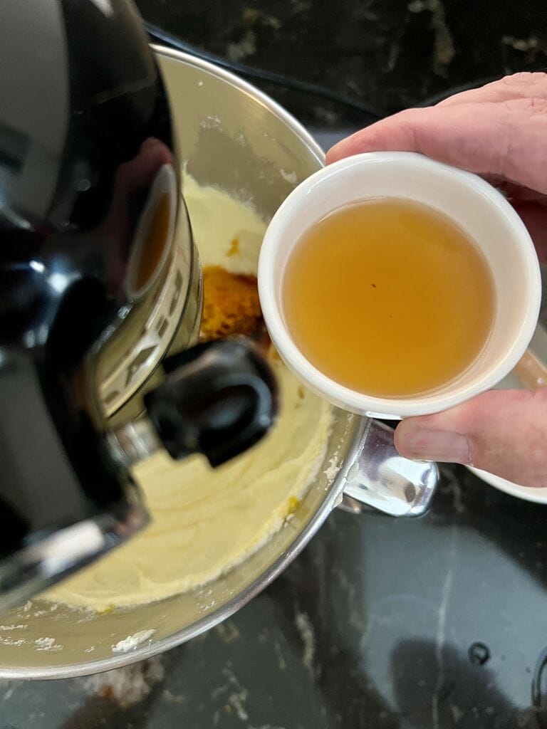 Adding the cognac into the batter.