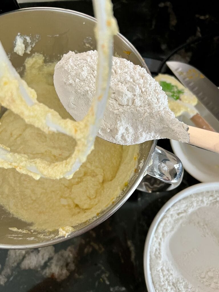 adding flour into the batter.